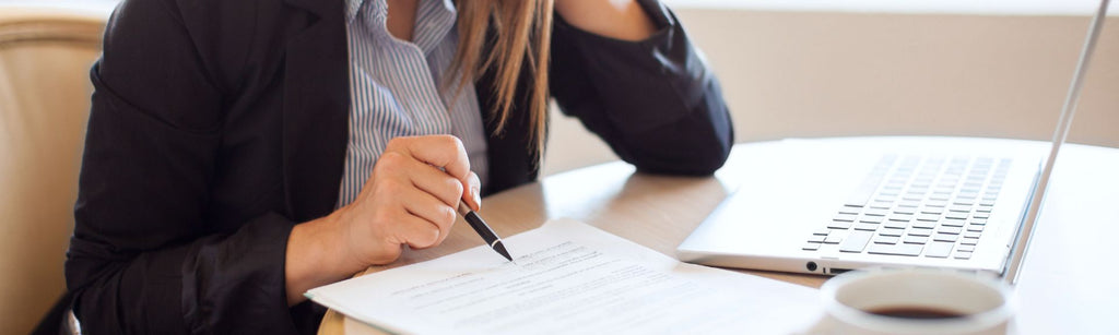 Business owner looking over document for mistake